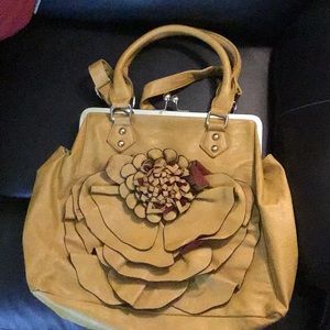Large leather yellow purse with a flower on the front